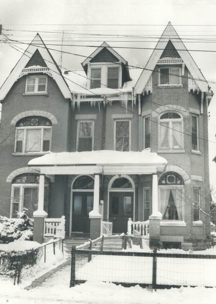 Historical winter scene of Victorian houses at 393 and 395 Manning Avenue covered in snow, where Toronto Western Hospital was founded in 1895