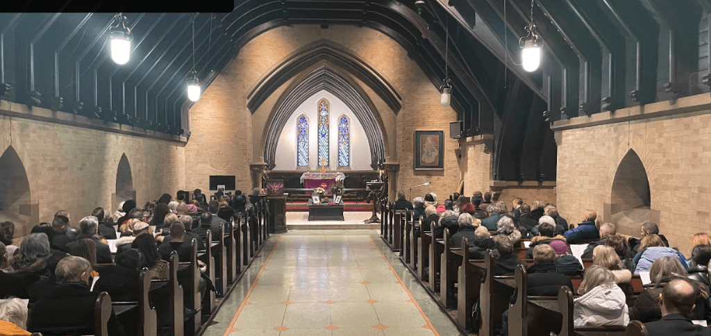 Interior of St. James Cemetery chapel showing Gothic architecture with vaulted ceiling and stained glass windows, where Alexander Manning was laid to rest