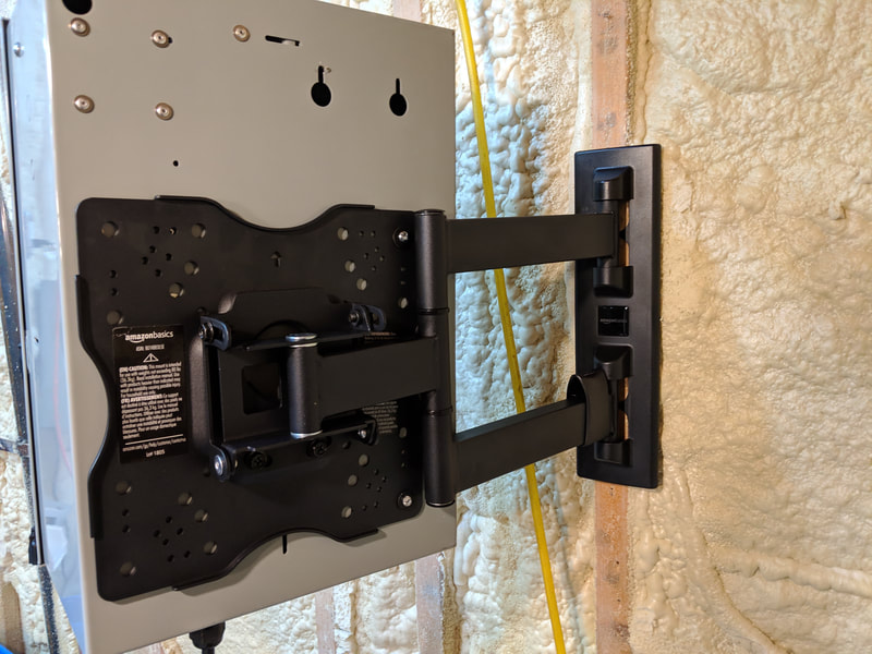 Articulating mount installed on wall showing extension capability