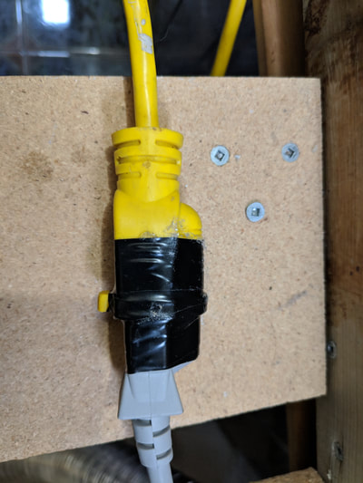 Close-up view of extension cord wrapped with electrical tape for secure connection