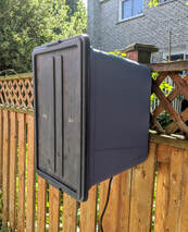 Outdoor timer box with weatherproof enclosure mounted on fence